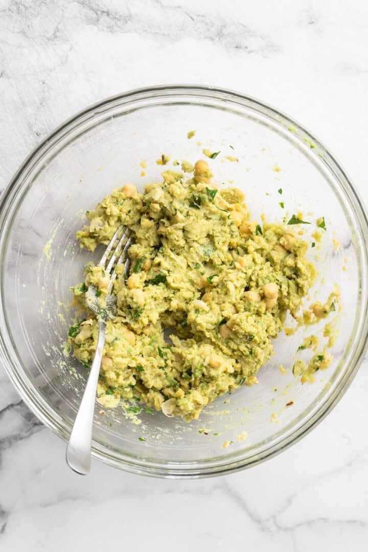 Smashed chickpea avocado salad in bowl with fork