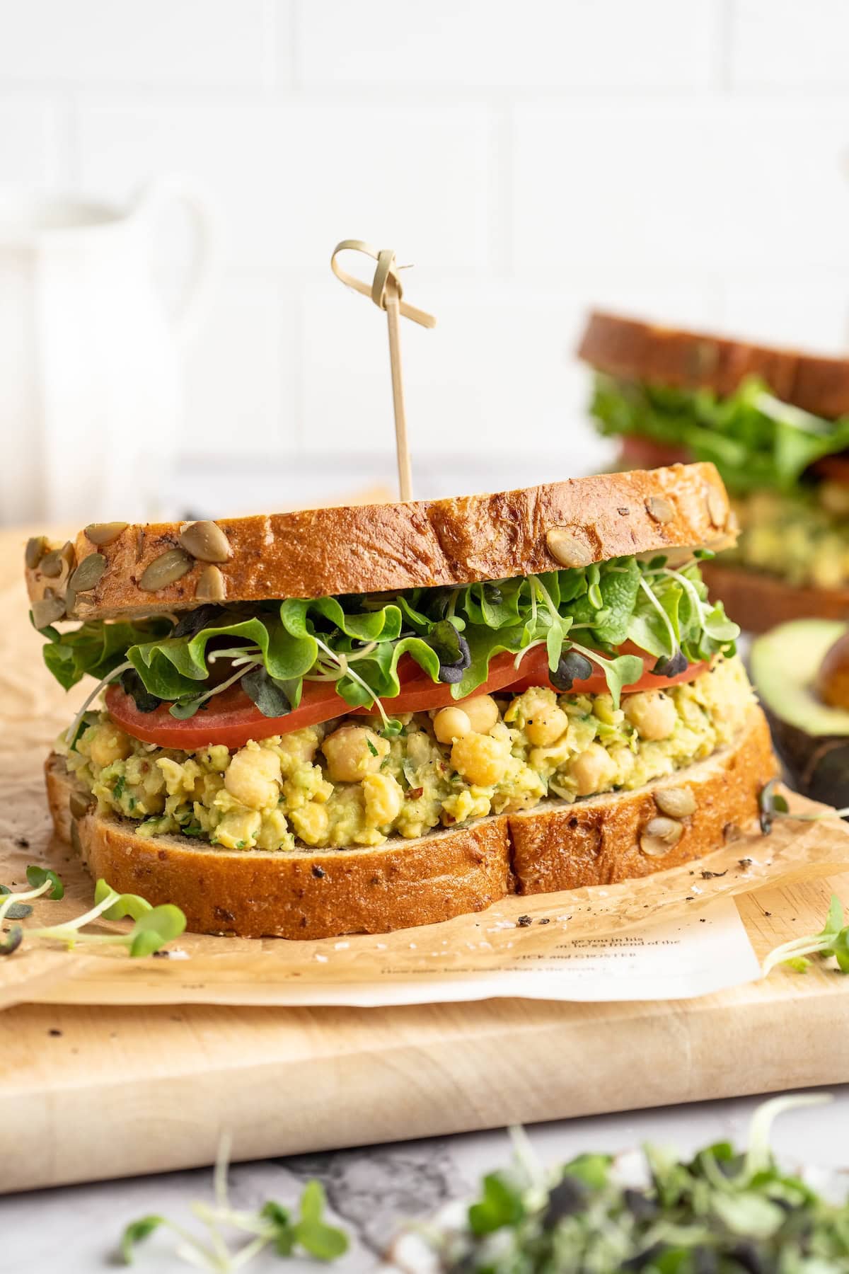 Smashed chickpea avocado salad sandwich with lettuce and tomato