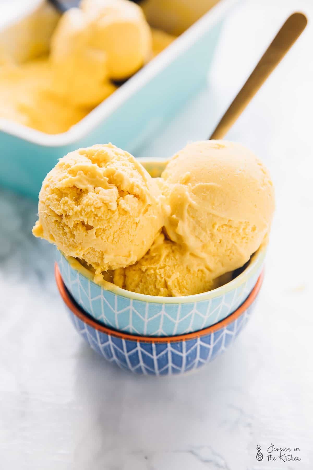 Three scoops of ice cream in a blue bowl. 