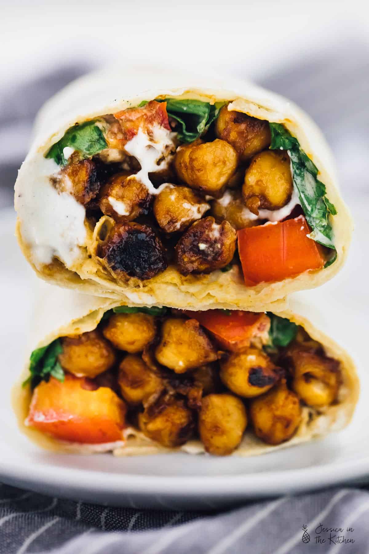Close up of bbq chickpea wrap cut in half. 