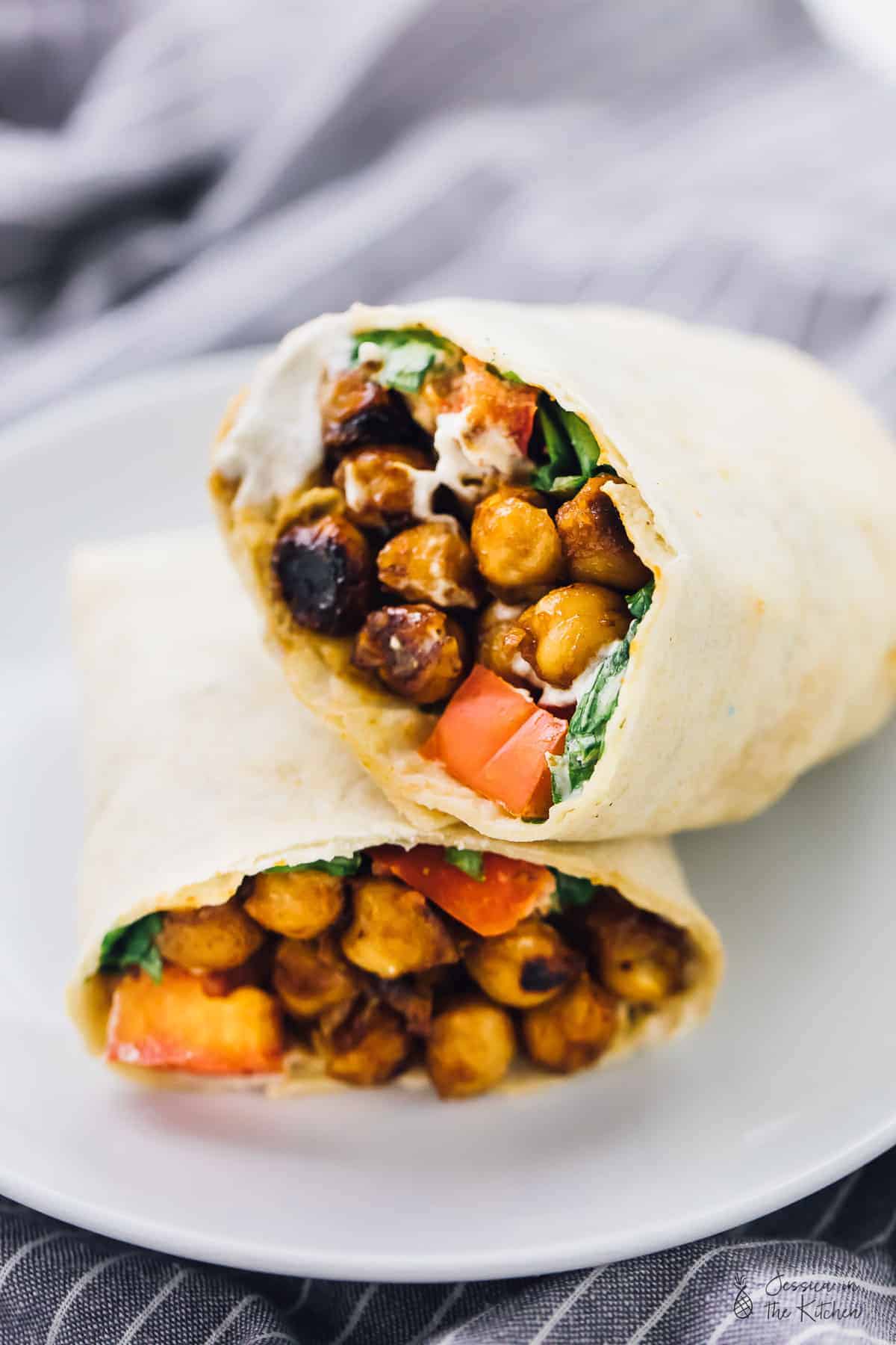 Two halves of a bbq chickpea wrap stacked on top of one another. 