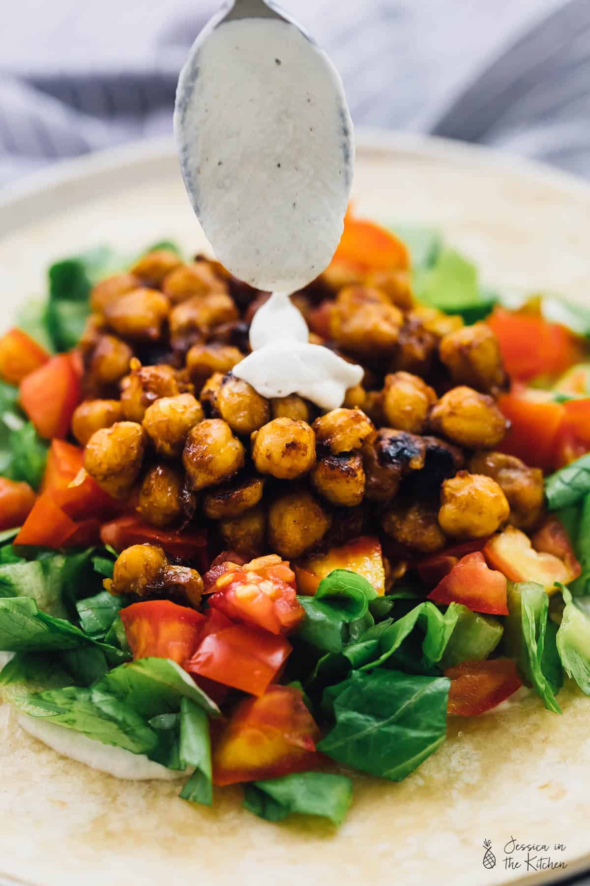 These BBQ Chickpea Wraps are an easy and quick lunch for work or meal on the go! They're swrved with a creamy ranch dressing and very filling! via https://jessicainthekitchen.com