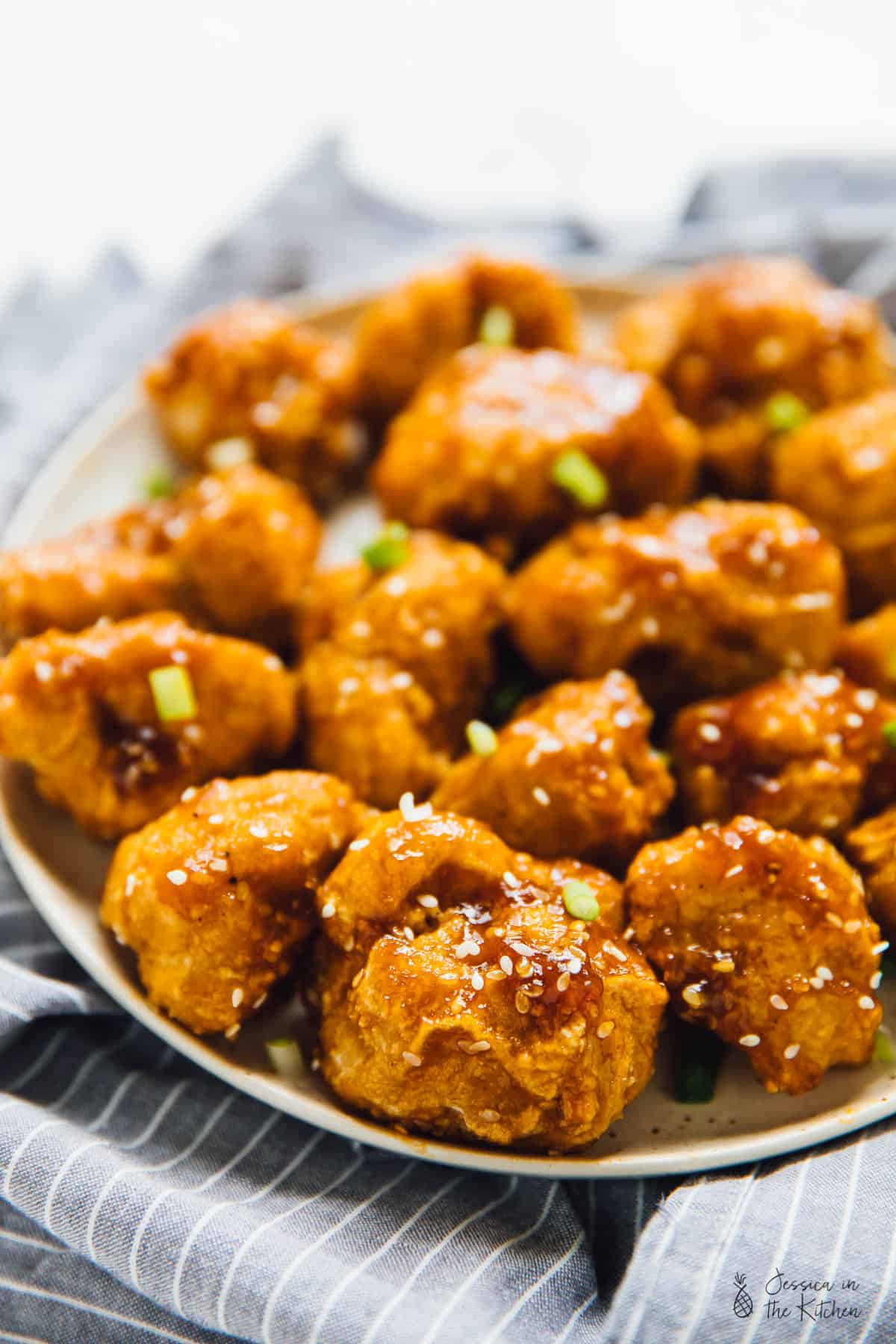 Close up of orange cauliflower bites on a plate. 