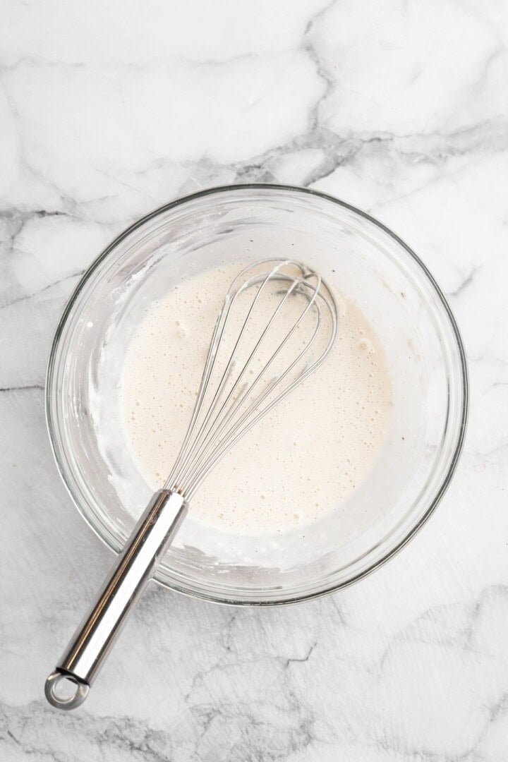 Overhead view of batter in bowl with whisk