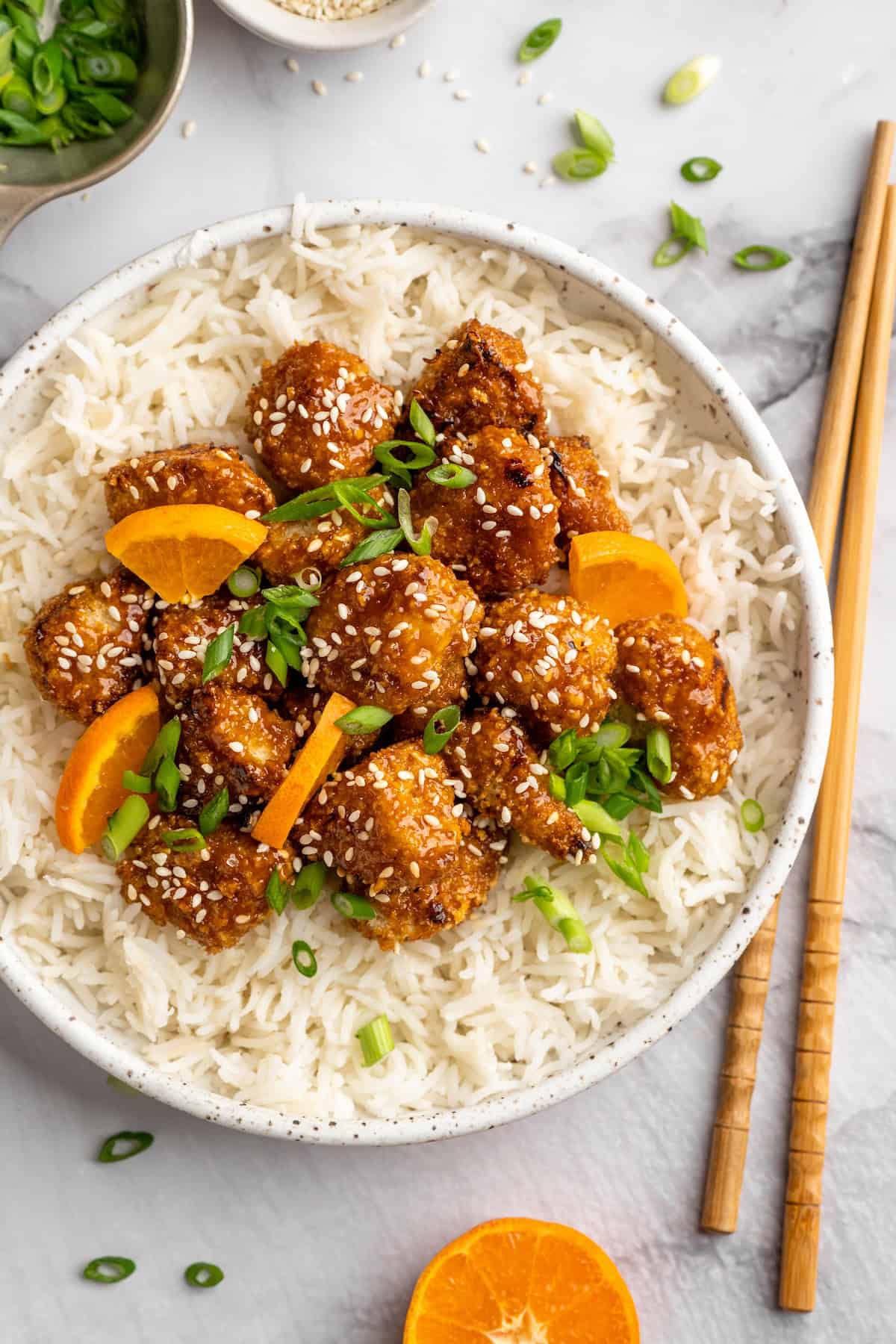 Overhead view of orange cauliflower in bowl with rice