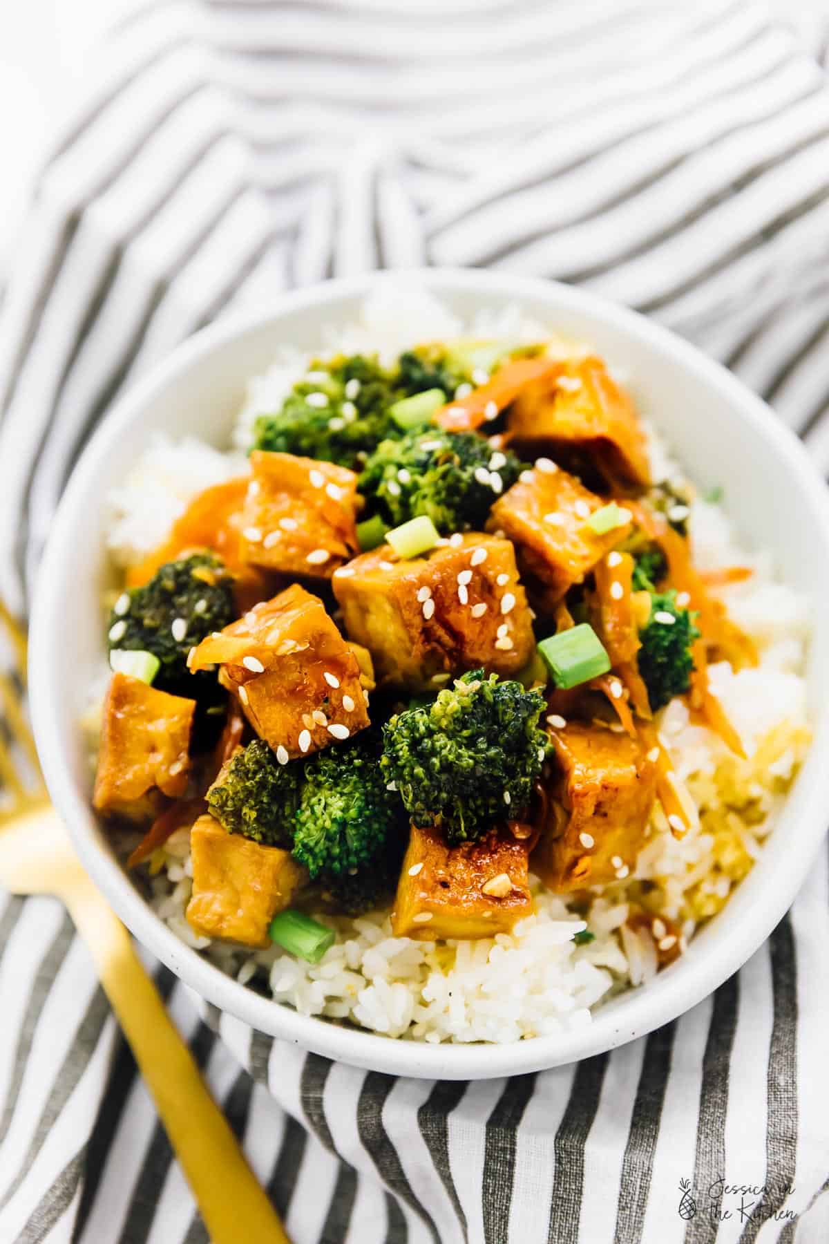 Tofu and broccoli on a bed of rice.