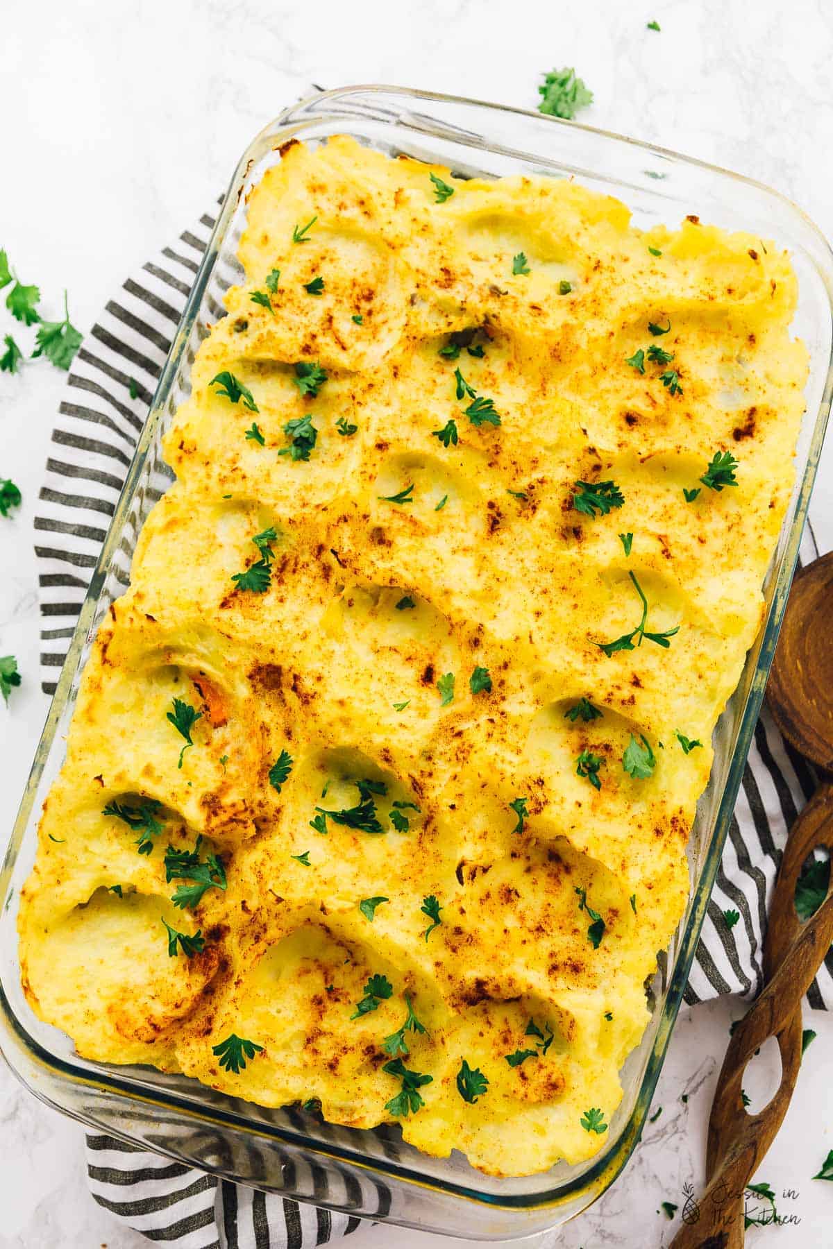 Top down view of vegan shepherd's pie in a glass baking dish. 