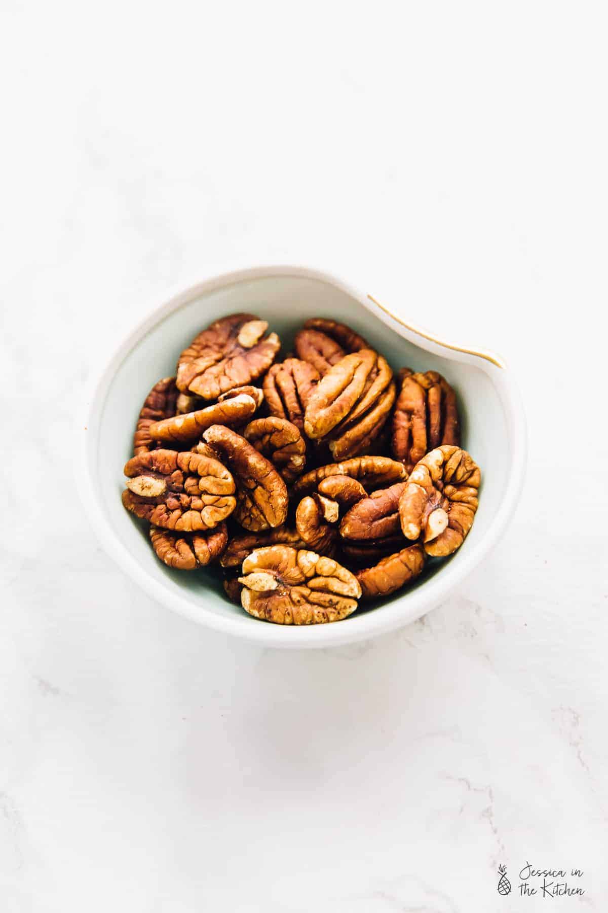 Overhead view pecans in a bowl. 