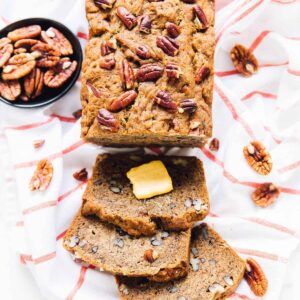 Overhead view of moist and delectable banana bread, sliced, on a table.