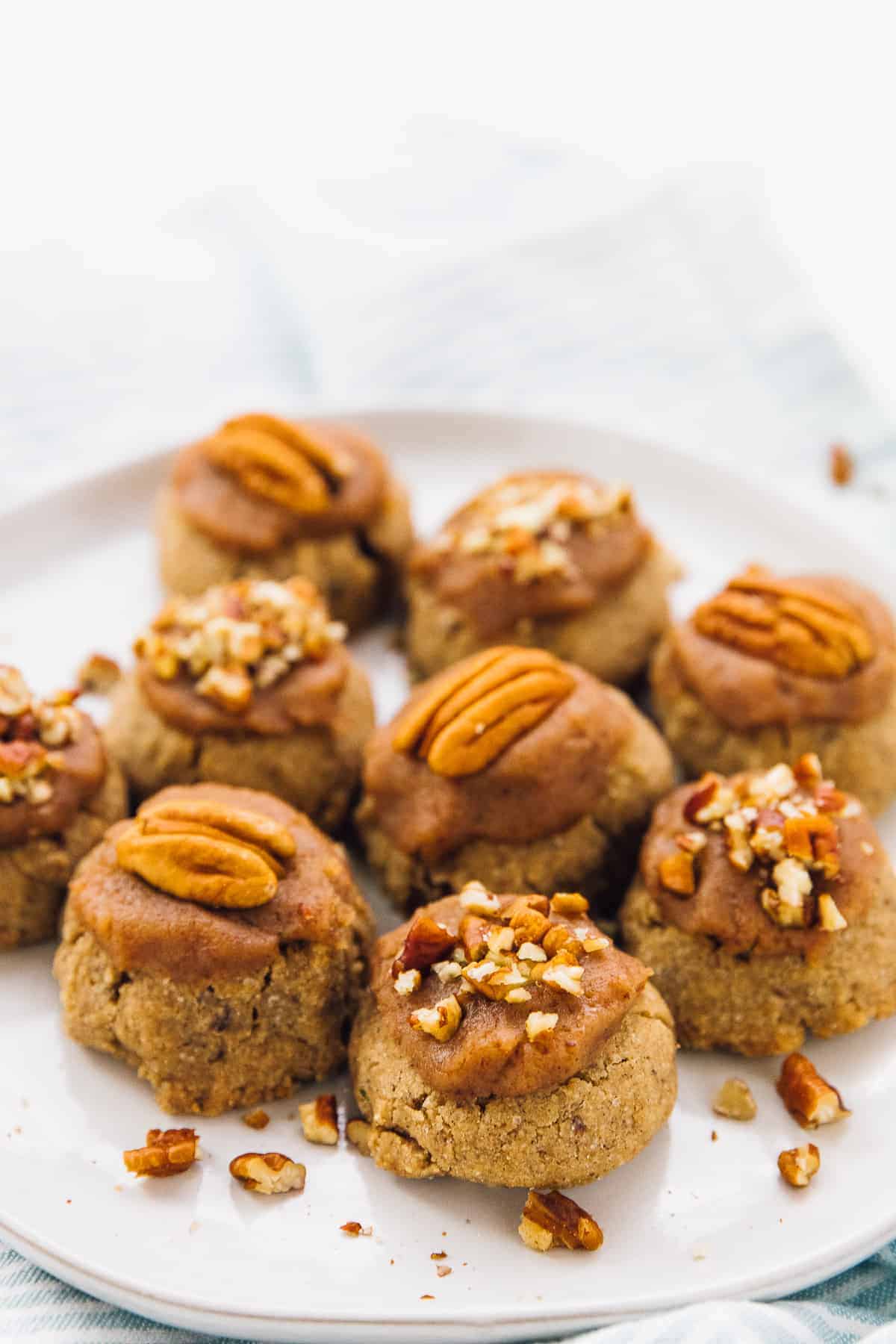 pecan cookies on a white plate close up shot 