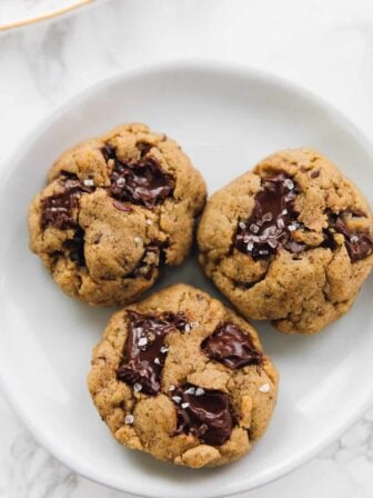3 Salted chocolate chip tahini cookies on a plate close up
