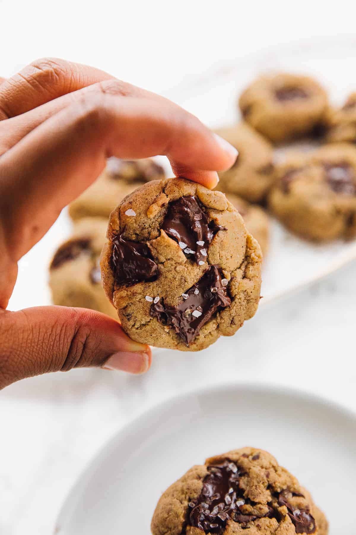 holding a Salted chocolate chip tahini cookie