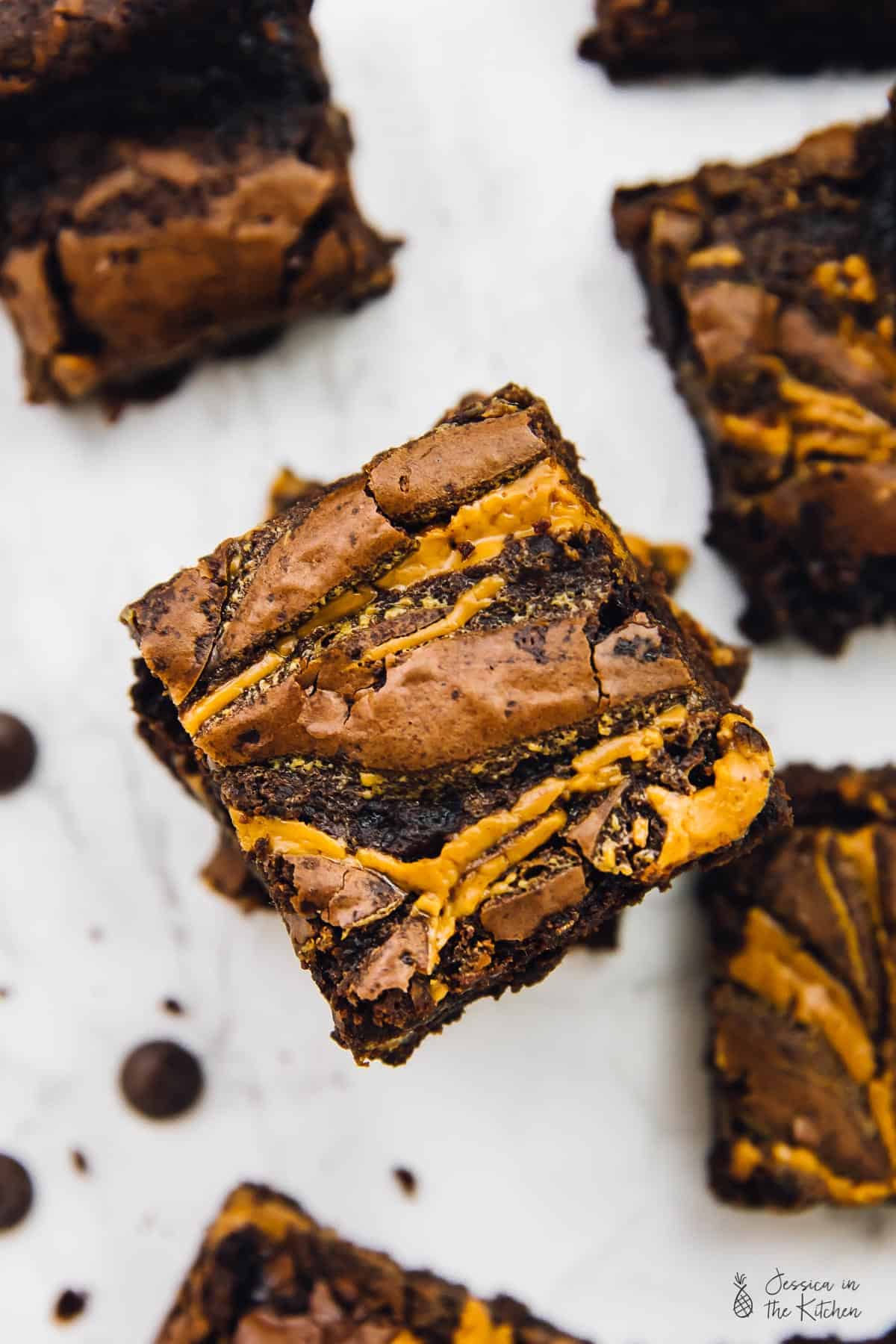 Overhead view of vegan brownies, stacked on a table. 