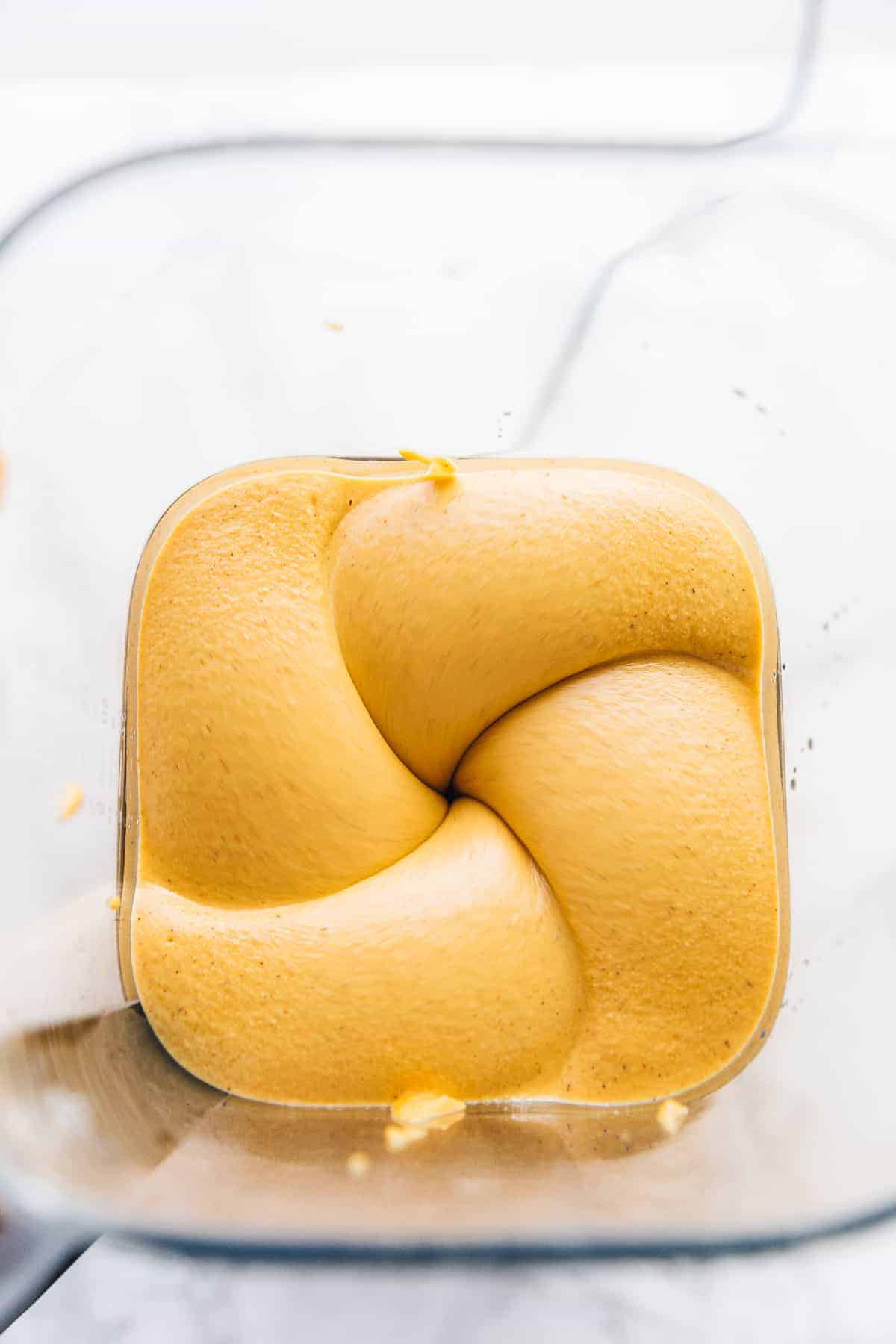 Overhead view of a blender blending cheesecake filling