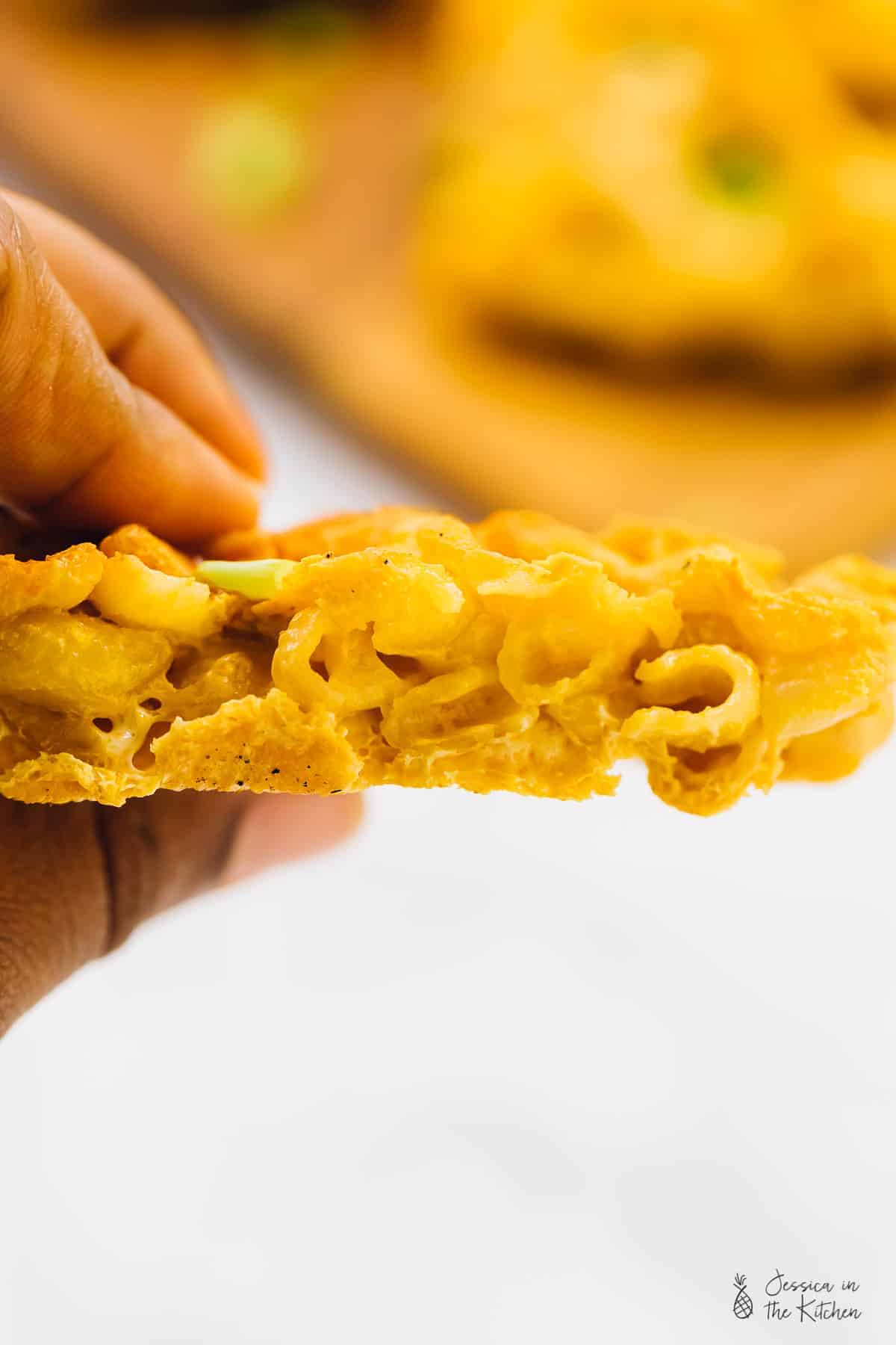 Side shot of a crispy mac and cheese waffle. 
