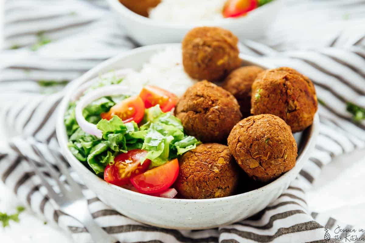 Lentil Balls in a bowl with rice and salad.