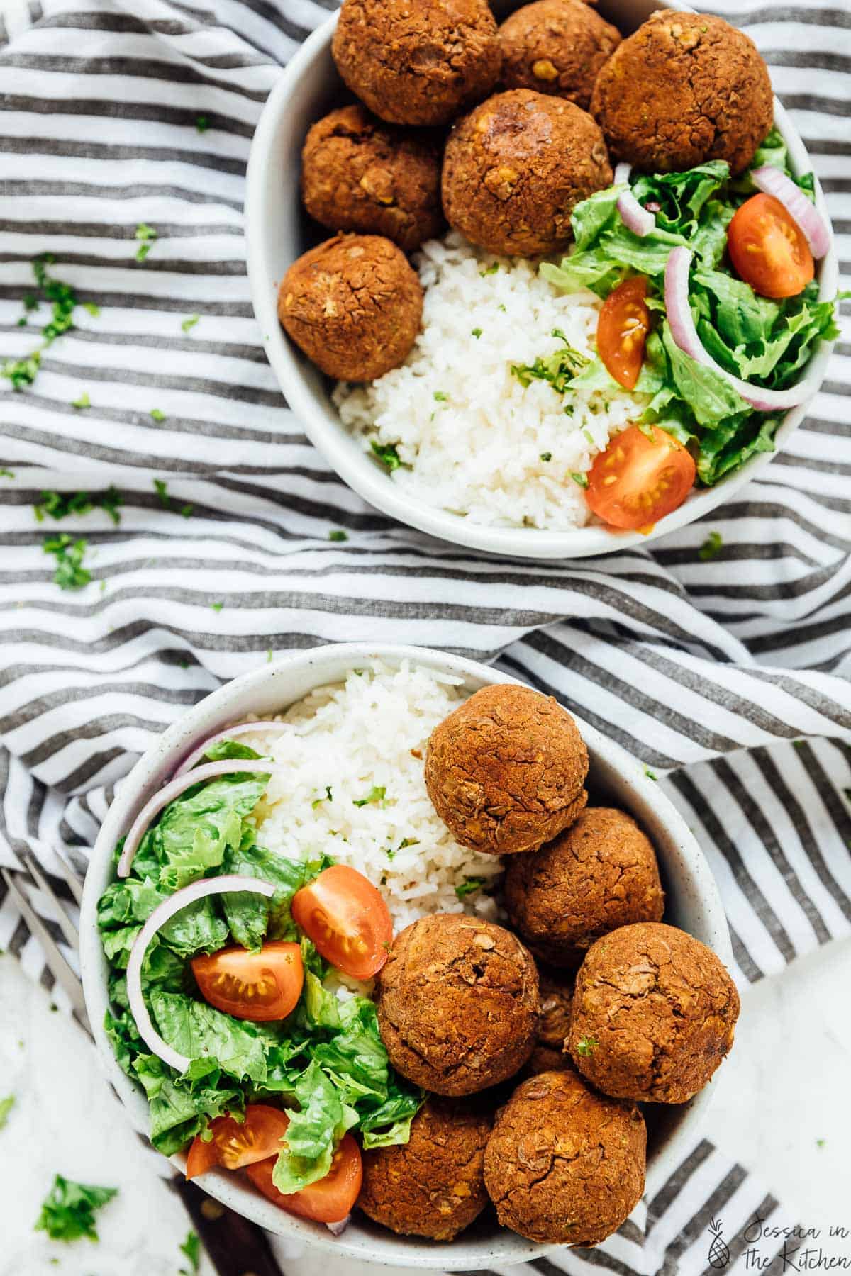 Overhead view of two bowls of lentil balls with zesty rice. 