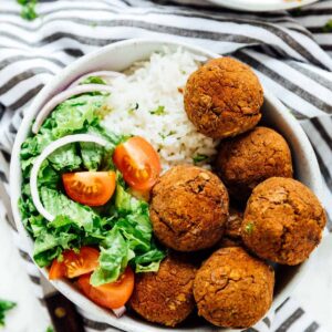 A bowl of lentil balls with salad.