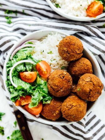 A bowl of lentil balls with salad.