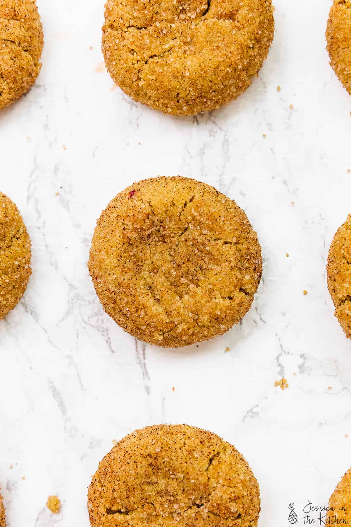 Close up overhead of snickerdoodle cookies with others peeking out at edges.