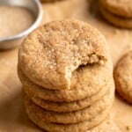Stack of vegan snickerdoodle cookies with top cookie bitten