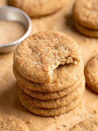 Stack of vegan snickerdoodle cookies with top cookie bitten