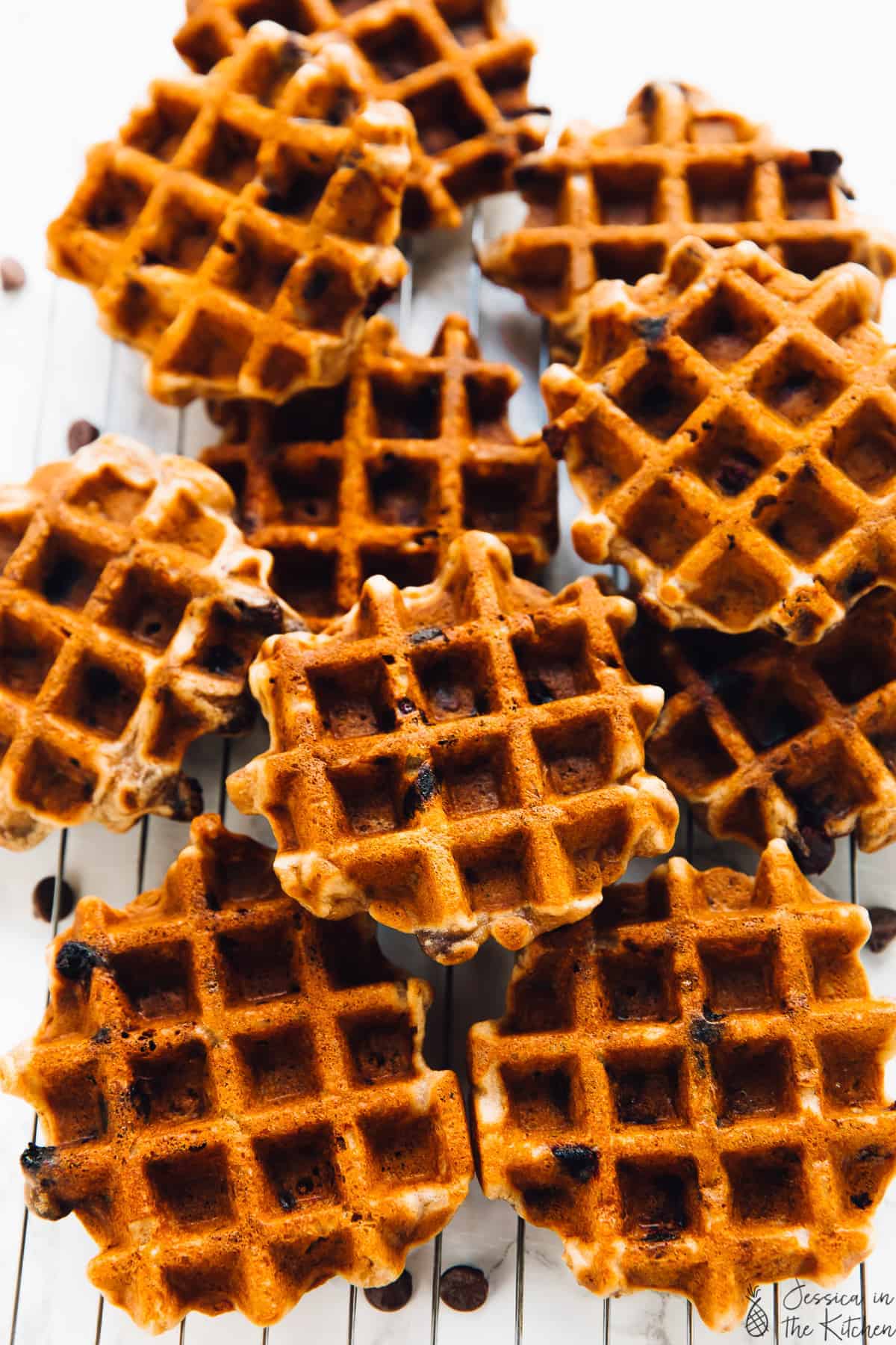 A batch of banana bread waffles on a wire rack.