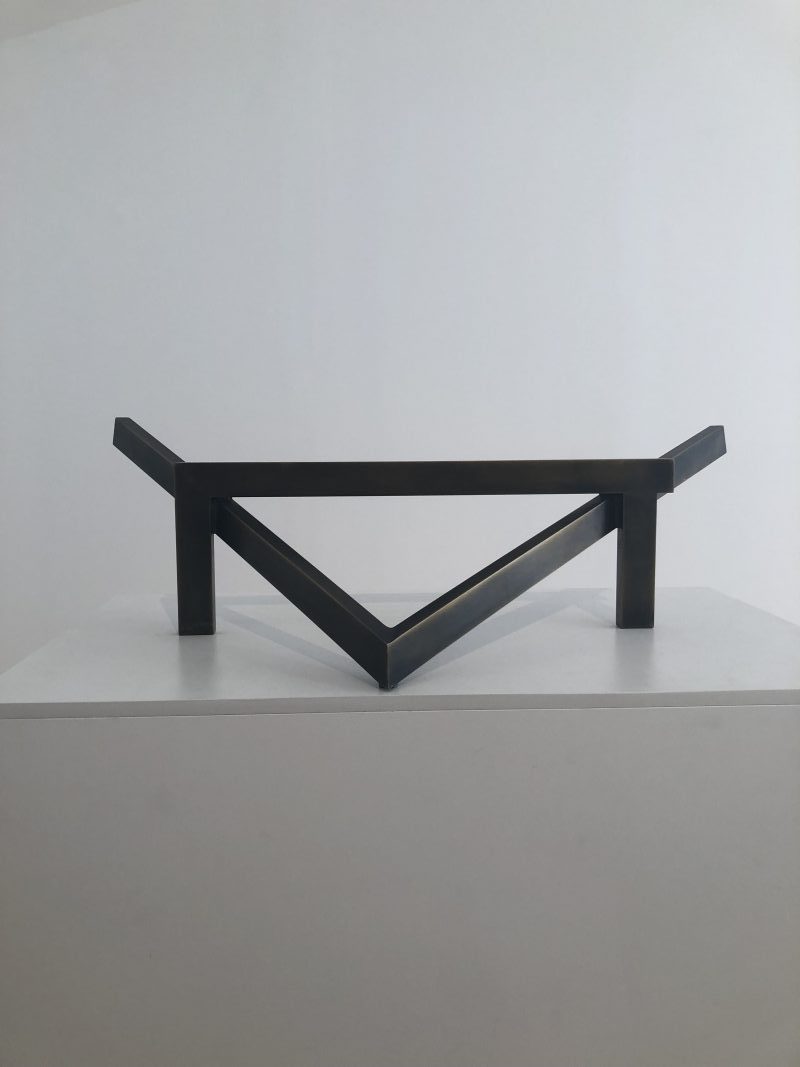 A metal sculpture on a table. 
