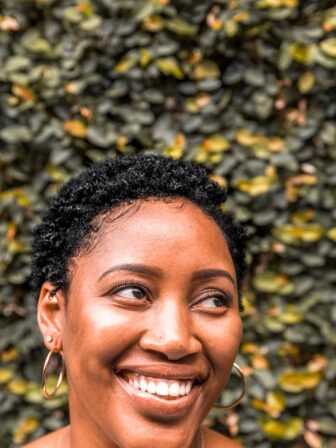 A lady with short hair, smiling for the camera.