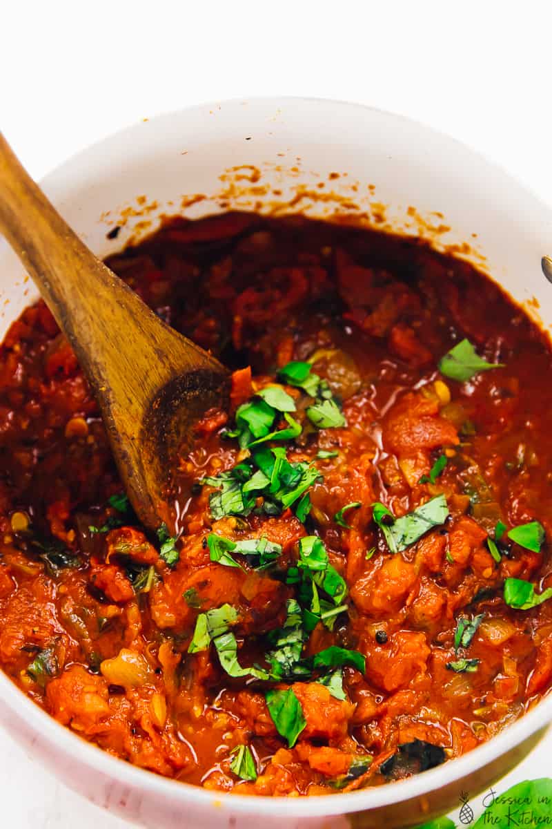 Spicy arrabbiata sauce in a bowl being stirred. 