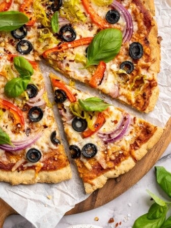 Top-down view of almond flour pizza slice pulled away from rest of pizza