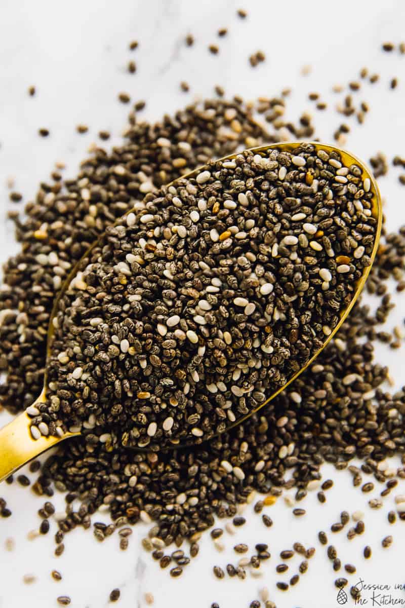 Chia seeds scattered over a spoon.