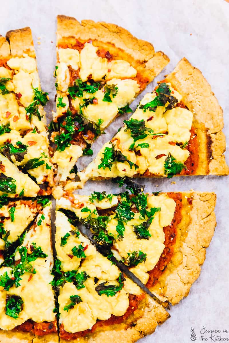 Top down view of a sliced pizza with vegan almond flour pizza crust.