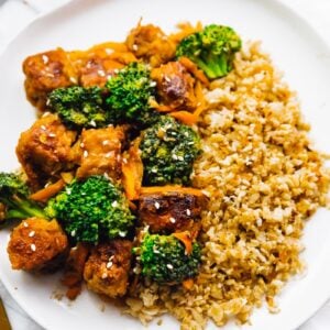 Tempeh stir fry on a white plate.