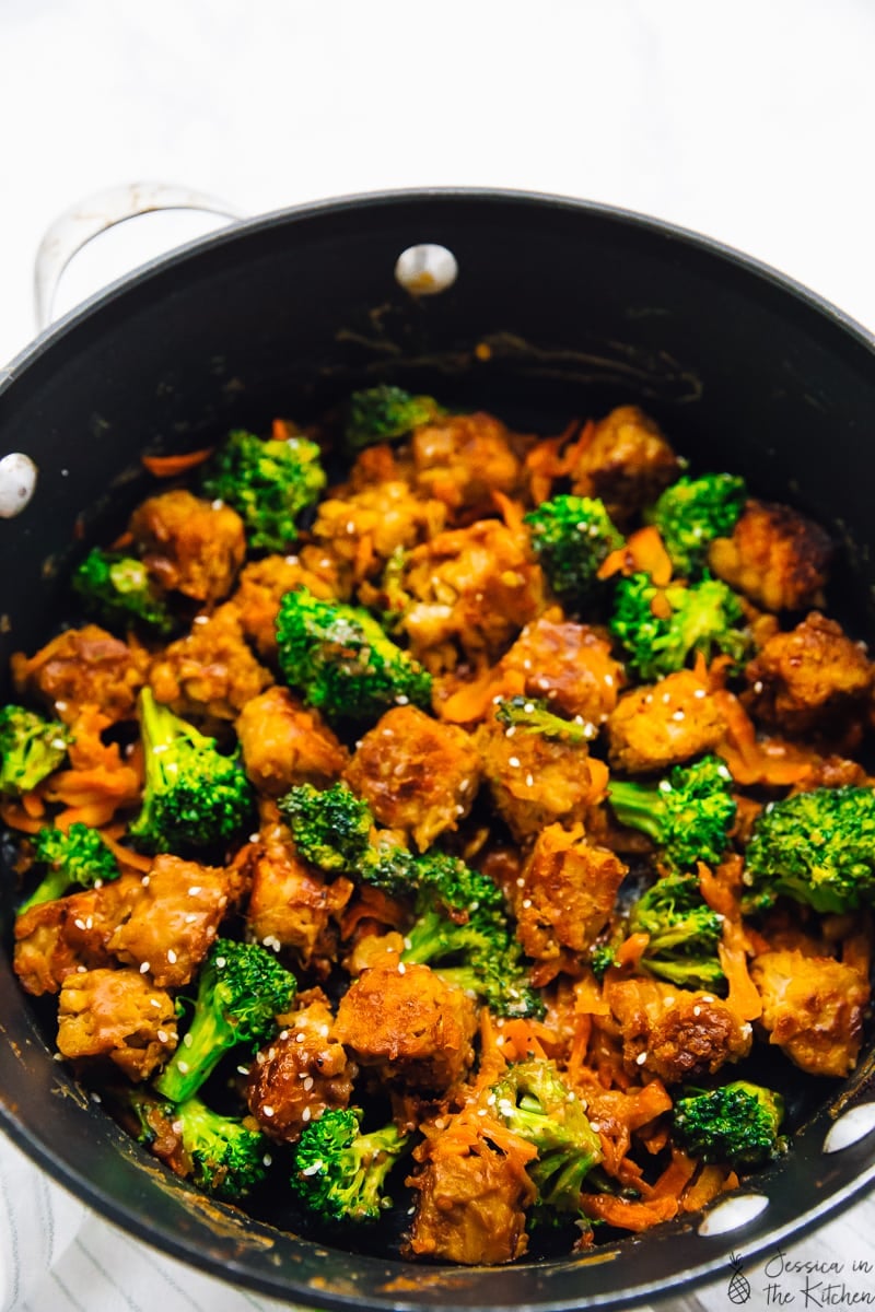 Overhead shot of tempeh stir fry in a black skillet. 