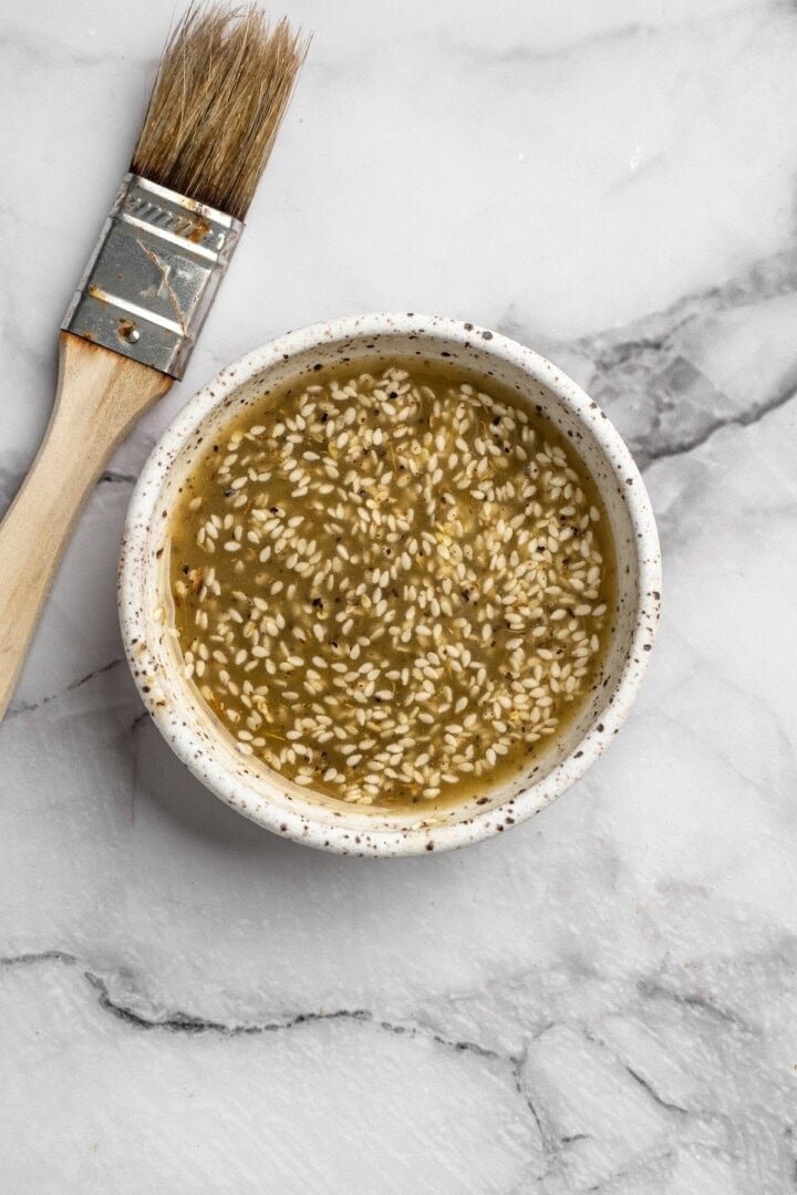 Overhead view of seasoning mixture for in bowl with brush