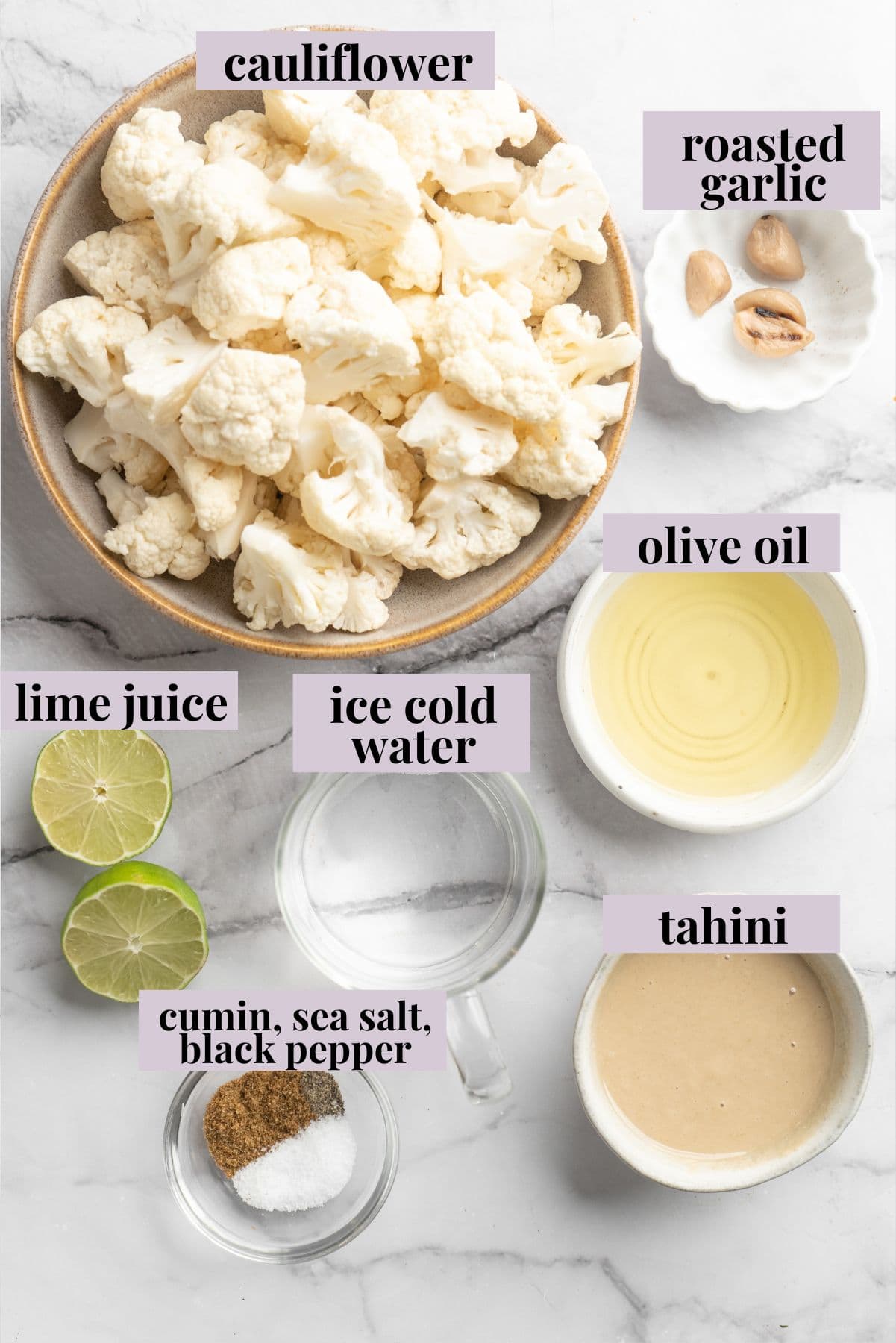 This easy Roasted Cauliflower Hummus gives the classic dip a low-carb makeover! I add roasted garlic too, which makes it extra delicious. Overhead view of ingredients for roasted cauliflower hummus