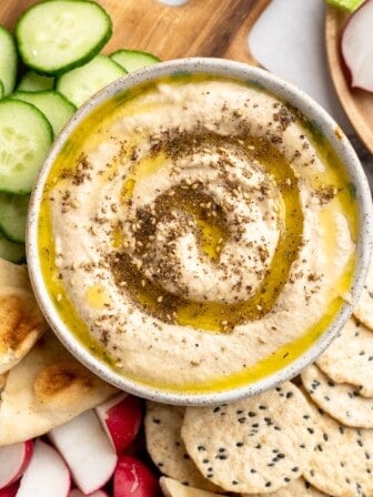 Overhead view of roasted cauliflower hummus with olive oil and za'atar