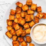 air fryer tofu on a plate with sauce