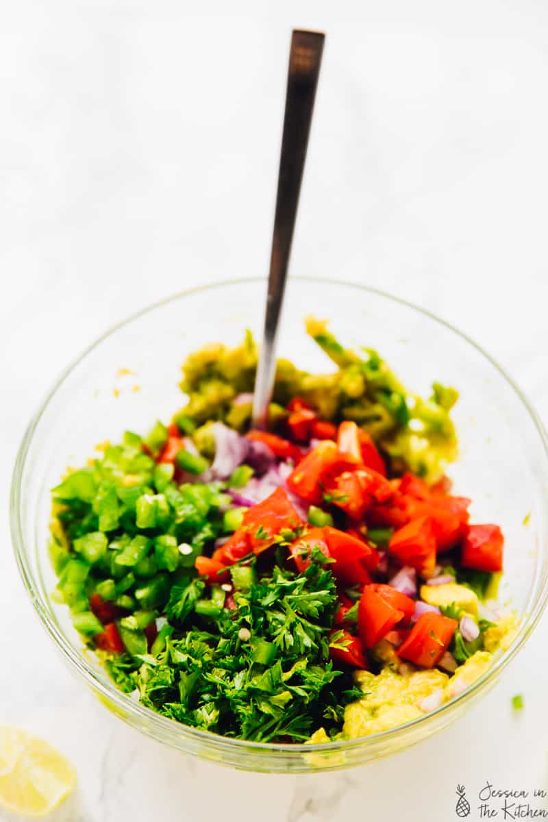 A mix of avocado, tomatoes, onions, parsley, lime and seasonings.