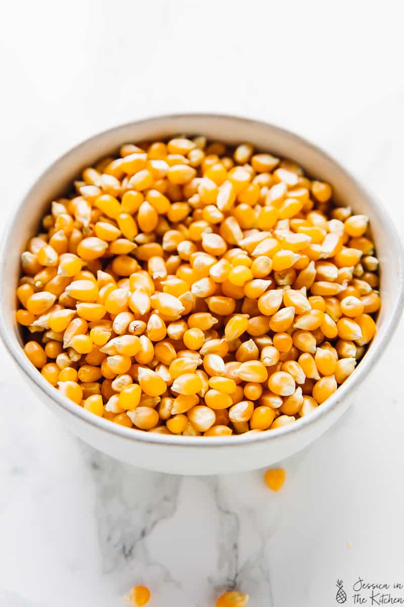 A bowl of organic unpopped corn kernels.