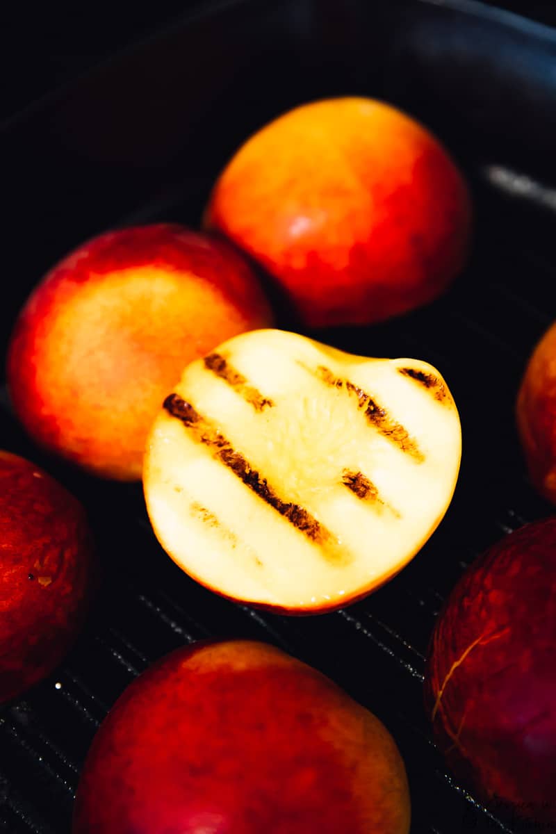 A grilled peach on a grill. 