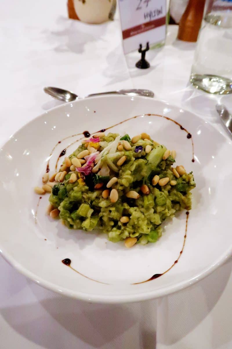 Overhead view of risotto on a large white plate. 