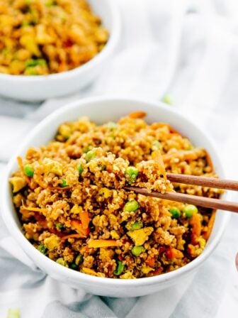 Vegan quinoa fried rice in chopsticks.