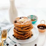 A stack of vegan chocolate chip pancakes on a plate.