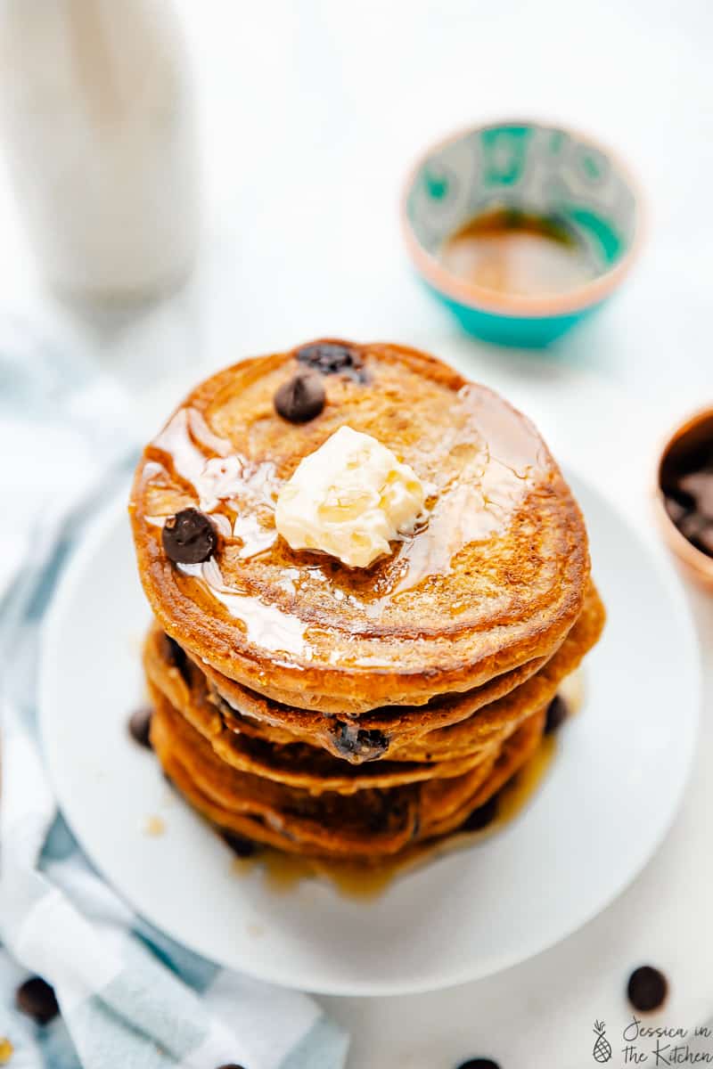 Top down view of a stack of vegan pancakes with chocolate chips.