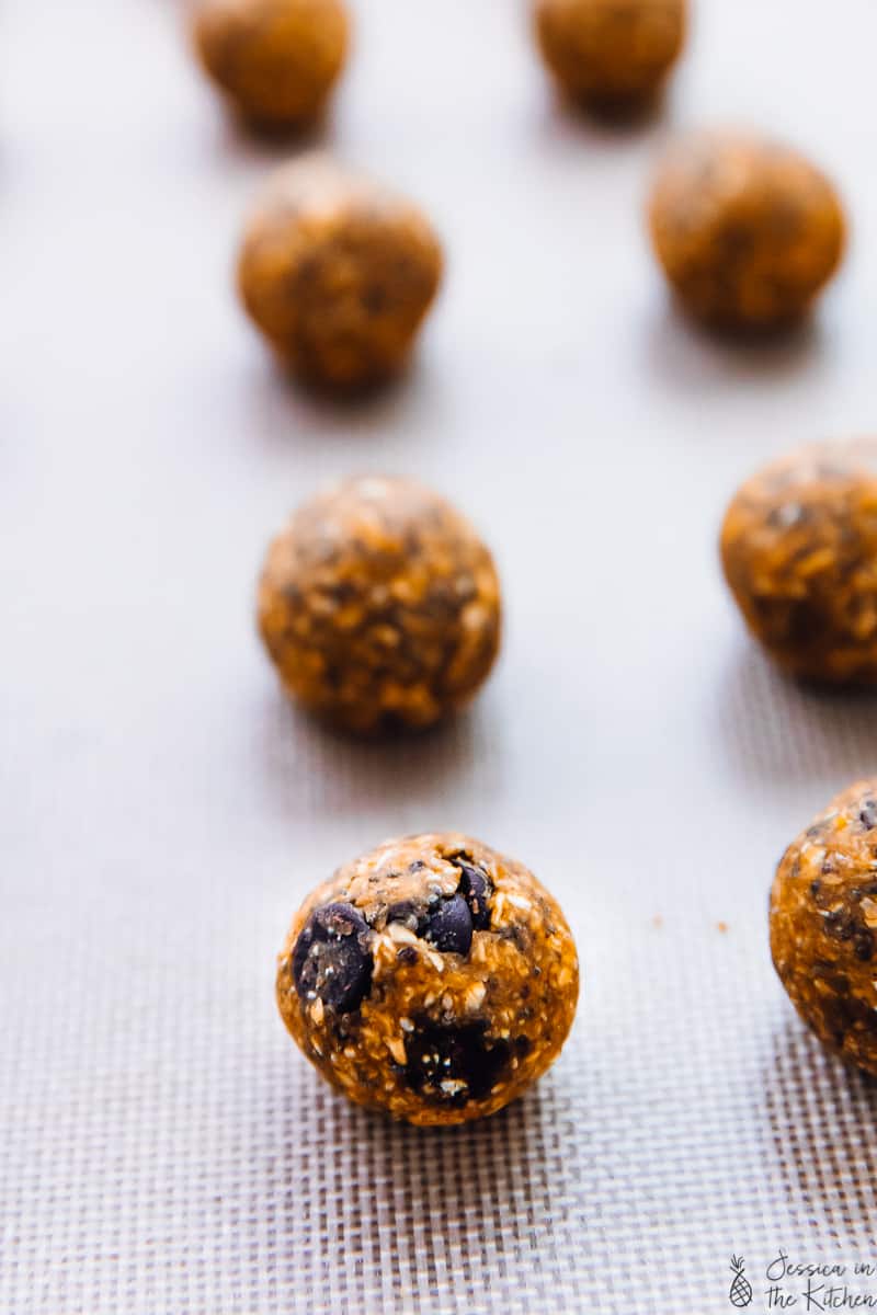 Rows of pumpkin energy bites on a baking sheet.