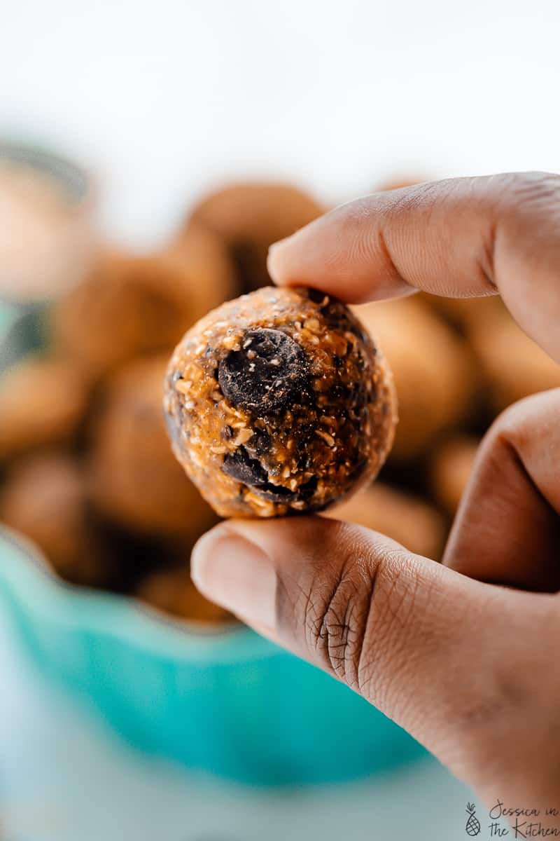 A hand holding a no bake pumpkin energy bites. 