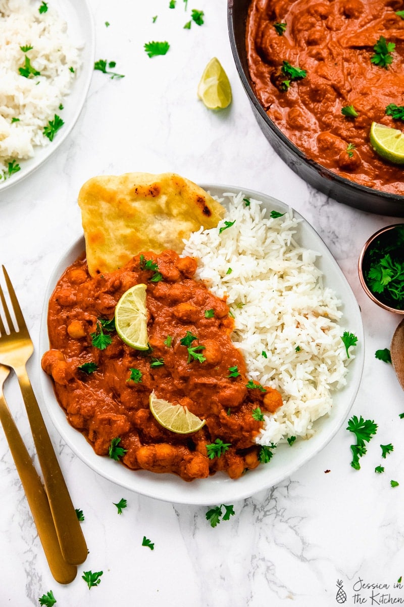 Chickpea tikka masala in a plate with rice and naan bread.