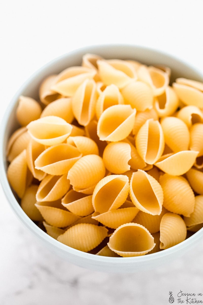 Bowl of uncooked pasta shells.